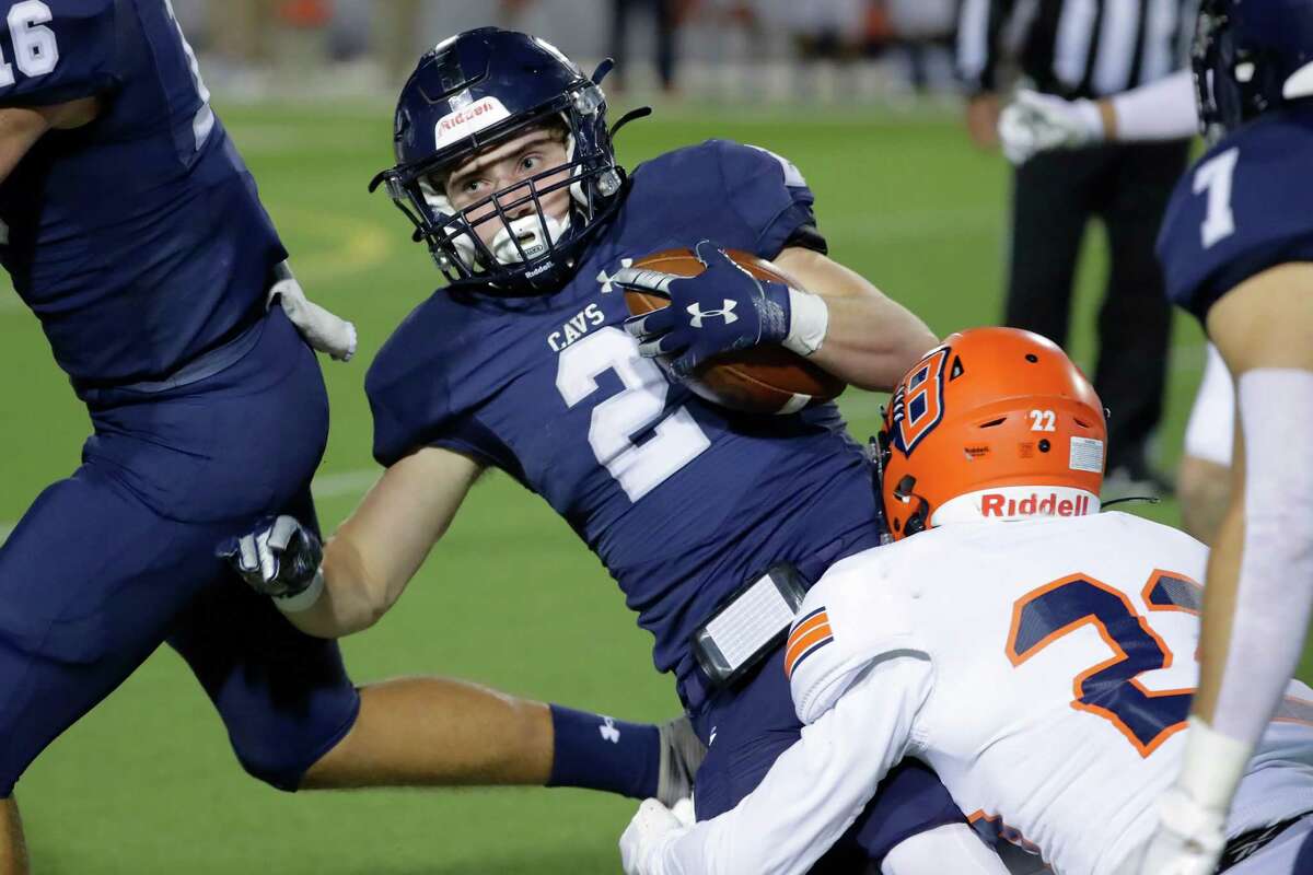 College Park wide receiver Conner Dunphy (2) is tackled by Bridgeland defensive back Bryce Bickham, right, during the first half of their Class 6A Division II area high school football playoff game Friday, Nov. 19, 2021 at Woodforest Bank Stadium in Shenandoah, TX.