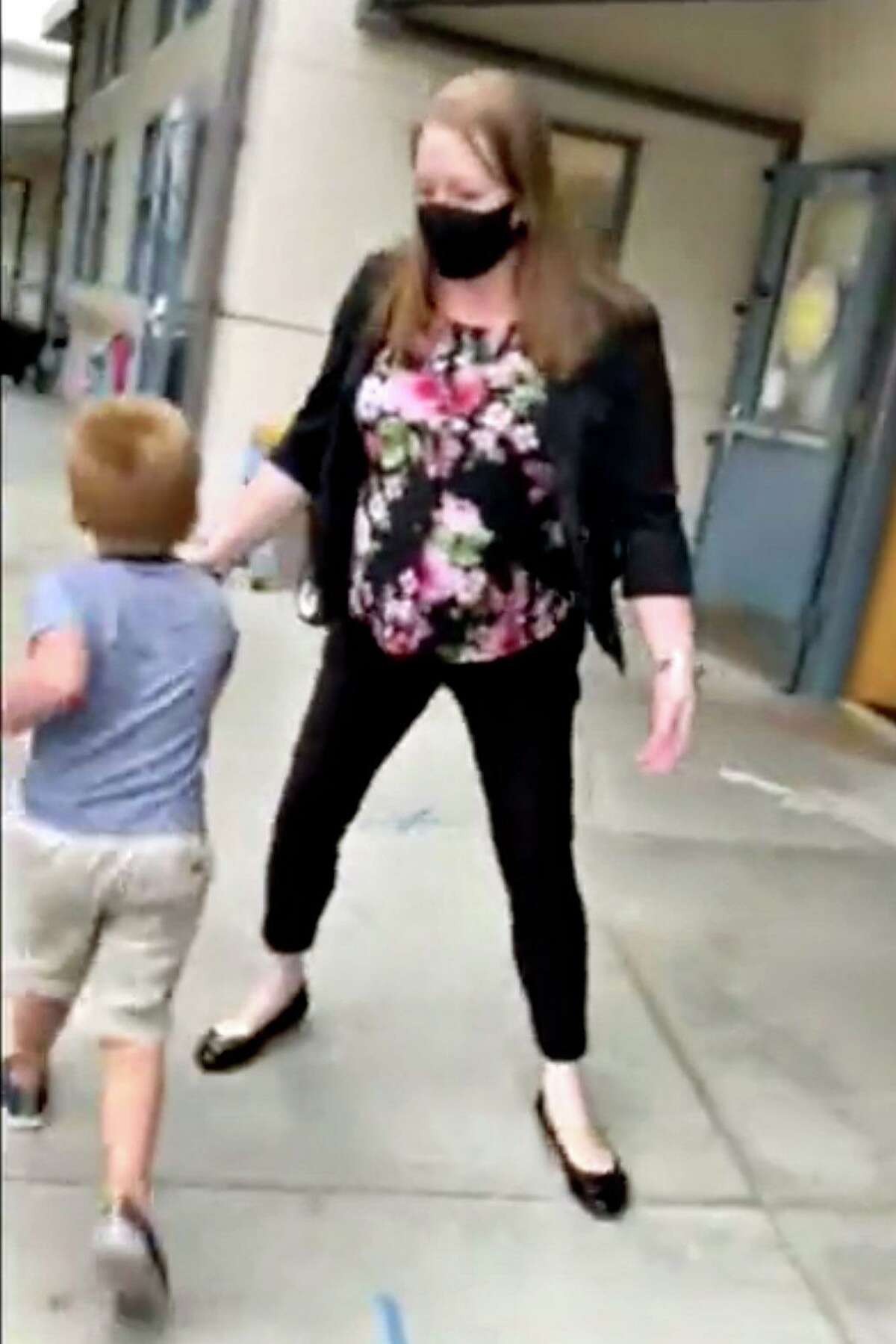 A school official at Theuerkauf Elementary in Mountain View prevents a 4-year-old transitional kindergarten student who refused to wear a mask from attending class. The incident, which included the principal calling a police officer to the scene, was recorded by the student’s father. Video image courtesy of the father, who identified himself only as Shawn for safety reasons.