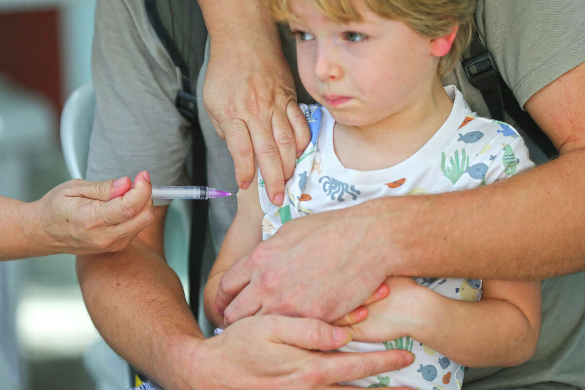 A girl receives a dose of a COVID-19 vaccine.