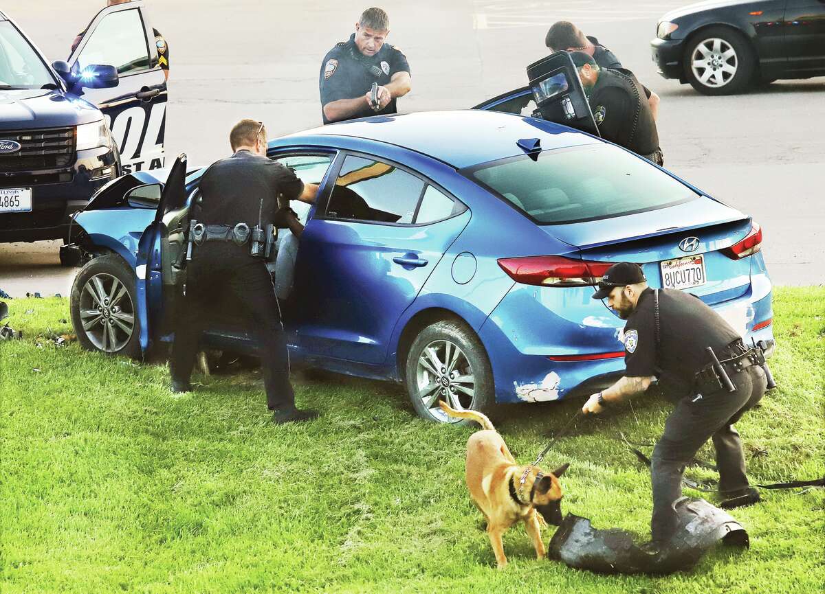 Officers, guns drawn, move in to arrest a woman after she lead police officers from multiple jurisdictions on a high speed chase through the Riverbend that lasted about 45 minutes. The woman eventually crashed at Fosterburg Road and College Avenue in Alton.