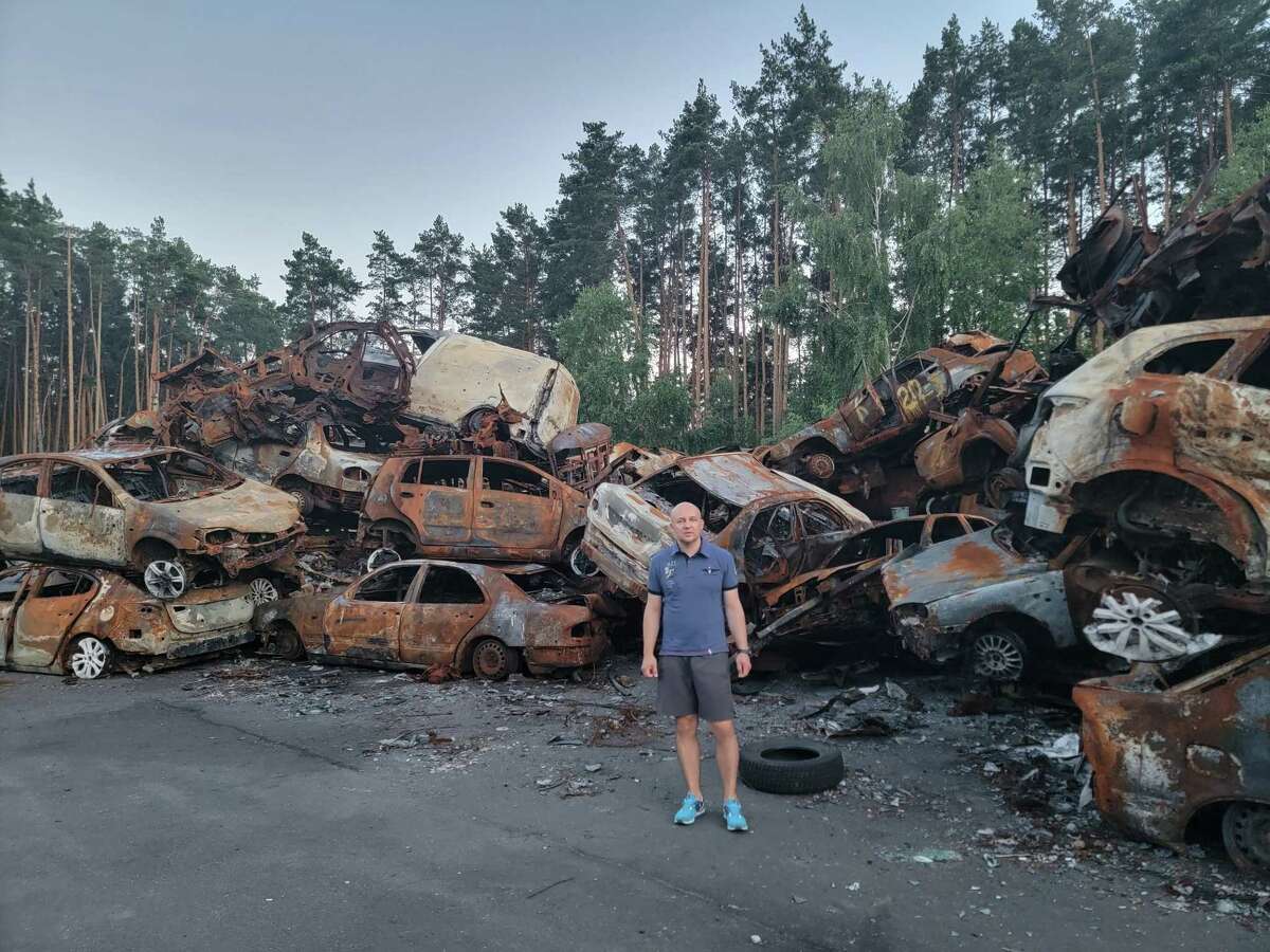 Ross Voytovych, who is from Ukraine but lives in Ridgefield, visited his home country earlier this year. He is pictured in damaged parts of Bucha and Hostomel in Ukraine.