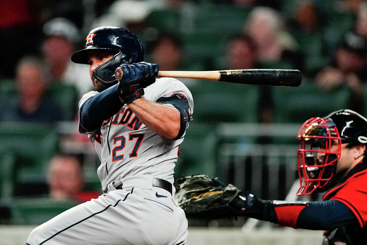 Houston Astros' Jose Altuve drives in a run with a base hit in the fifth Inning of a baseball game against the Atlanta Braves Friday, Aug. 19, 2022, in Atlanta. (AP Photo/John Bazemore)