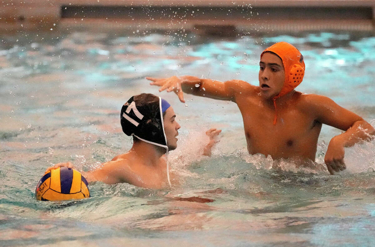 Elkins' Elias Alarcon (7) battles against Austin's Joaquin Rosales (17) during the first half of a boys high school water polo match between Fort Bend Austin and Fort Bend Elkins at Don Cook Natatorium on Friday, Aug. 19, 2022 in Sugar Land.