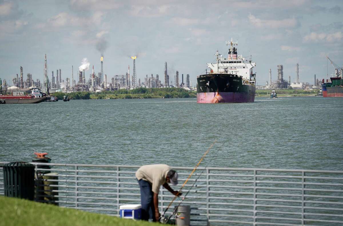 The Nordic Masa makes it way down the Houston Ship Channel as a man fishes from shore Saturday, Aug. 13, 2022, near the Battleship Texas in La Porte. The TCEQ received 52 water quality permit applications in the last month in Harris County. 
