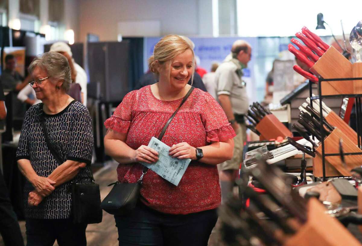 Visitors take in cutlery and other offerings during the annual Montgomery County Home and Outdoor Living Show at the Lone Star Convention & Expo Center, Saturday, Aug. 20, 2022, in Conroe.