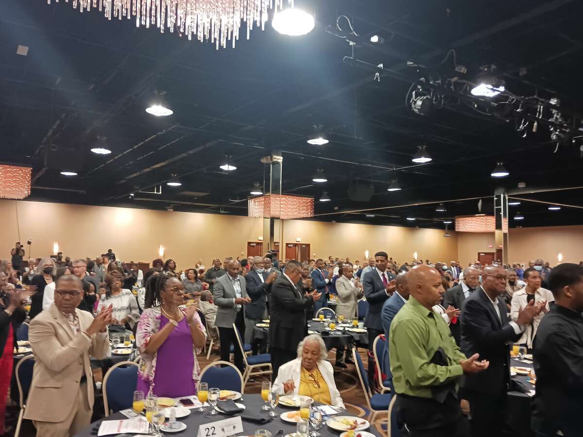 Attendees rise in applause at the First Annual Slavery Remembrance Day breakfast Aug. 20, 2022.