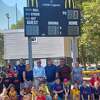 Annex Little League celebrated the unveiling of two new scoreboards on Saturday. Adults standing back row left-right, Rep. Al Paolillo, board member Sara Amato, McDonald's owner Roger Facey, Annex LL president Chip Porto, Gramen Wilson and board member Sal Punzo.