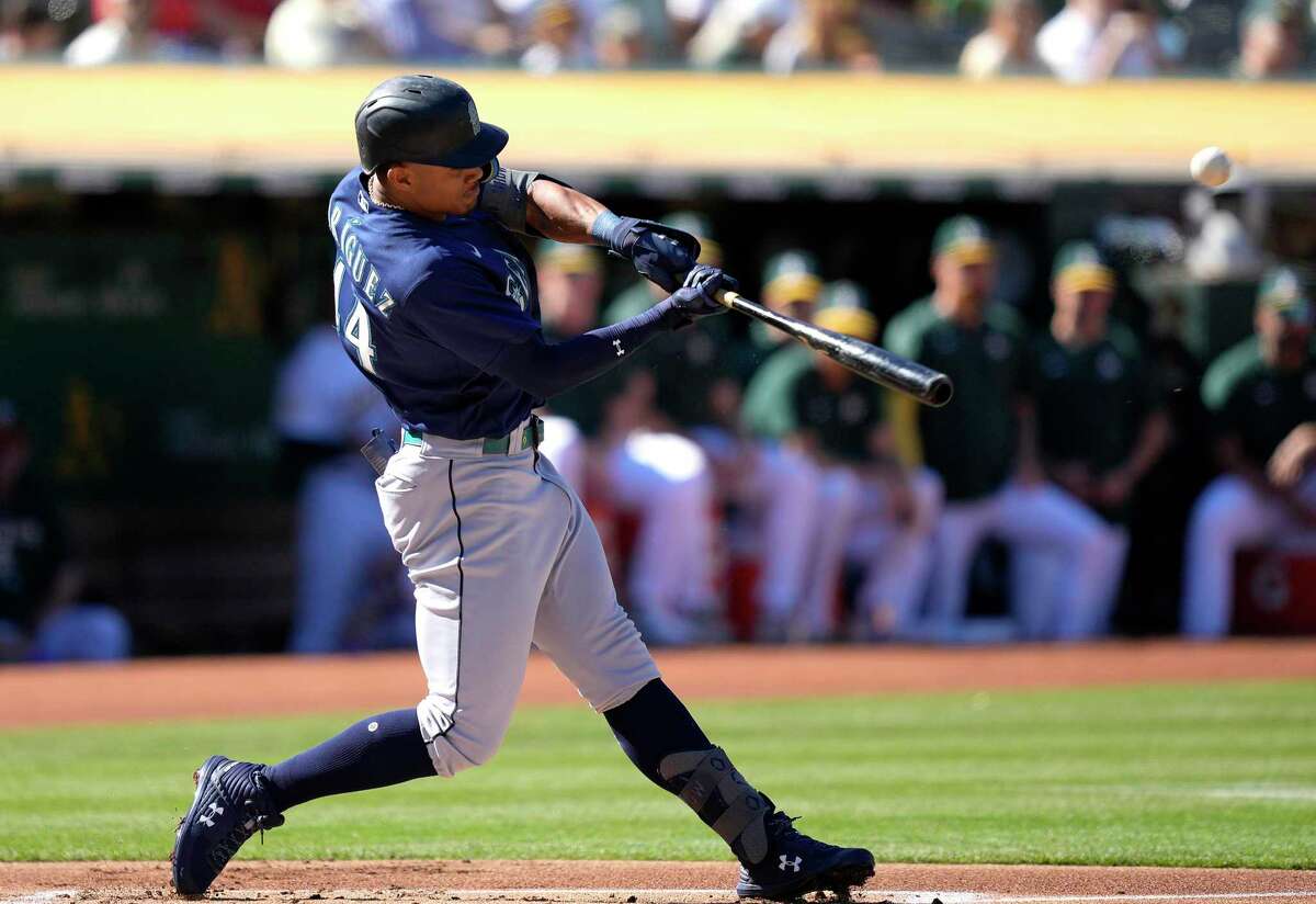 OAKLAND, CALIFORNIA - AUGUST 20: Julio Rodriguez #44 of the Seattle Mariners hits a lead-off triple against the Oakland Athletics in the top of the first inning at RingCentral Coliseum on August 20, 2022 in Oakland, California. (Photo by Thearon W. Henderson/Getty Images)