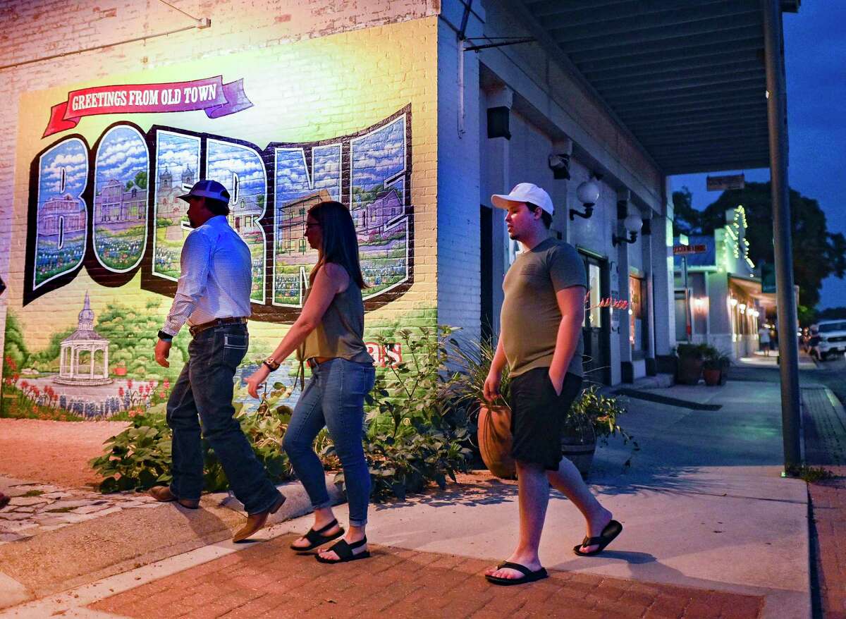 People enjoy a walk on South Main Street in Boerne on Friday night, Aug. 19, 2022. Boerne’s Hill Country Mile, along South Main Street, has many shops that specialize in antiques, jewelry, coffee and art, as well many restaurants that range from barbecue to Spanish tapas to burgers. The city hopes that its SoBo development will keep workers in town after work to eat and enjoy nightlife.
