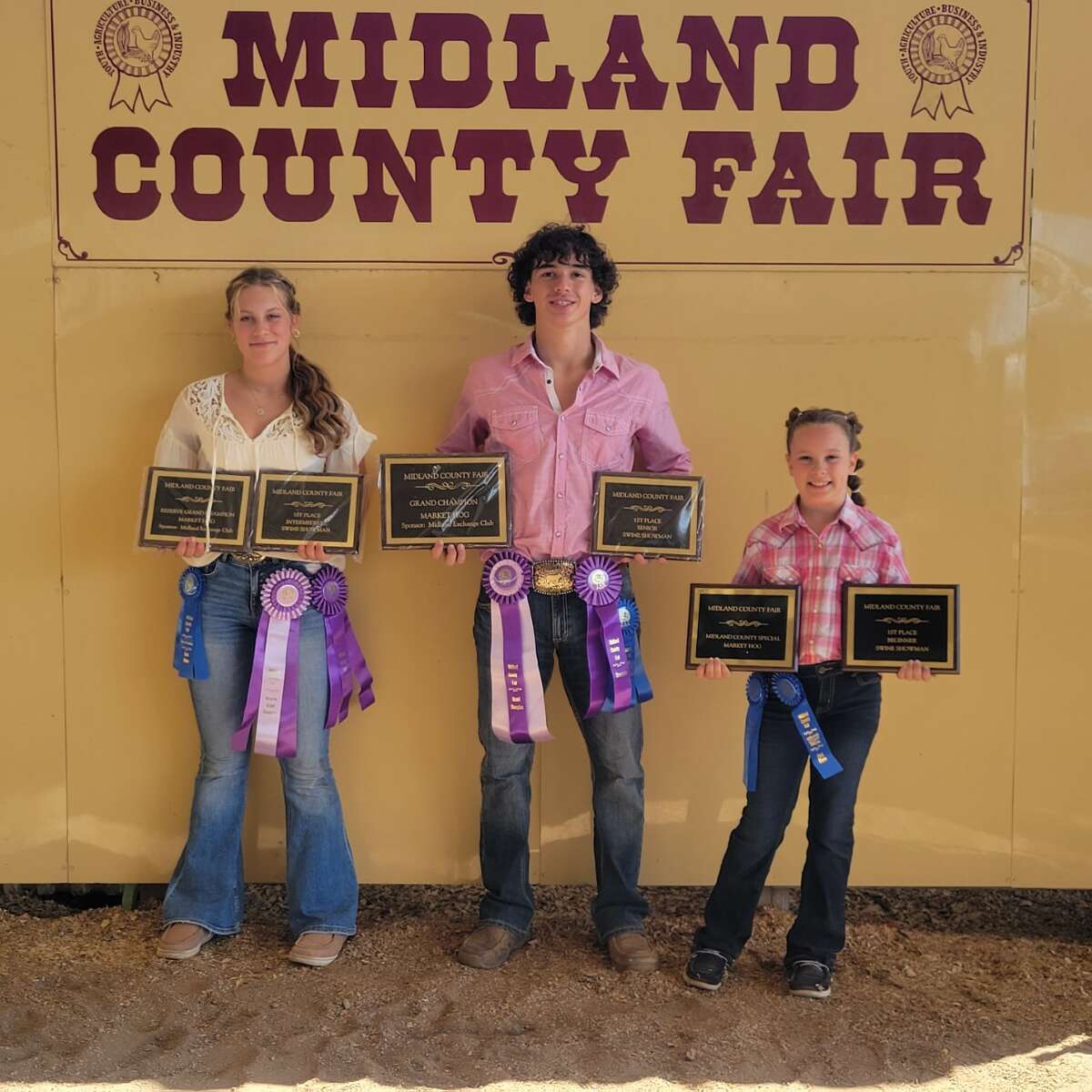 Coleman siblings, from left, Victoria Kennedy, 14, Isaiah Biers, 16, and Teagan Kennedy, 10, show their awards at the Midland County Fair this past week.