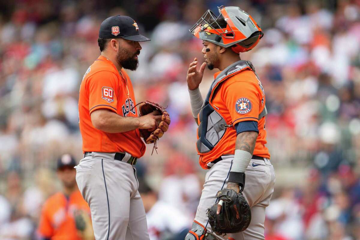 Houston Astros catcher Martin Maldonado, right, speaks with starting pitcher Jose Urquidy, left, in the first inning of a baseball game against the Atlanta Braves, Sunday, Aug. 21, 2022, in Atlanta.