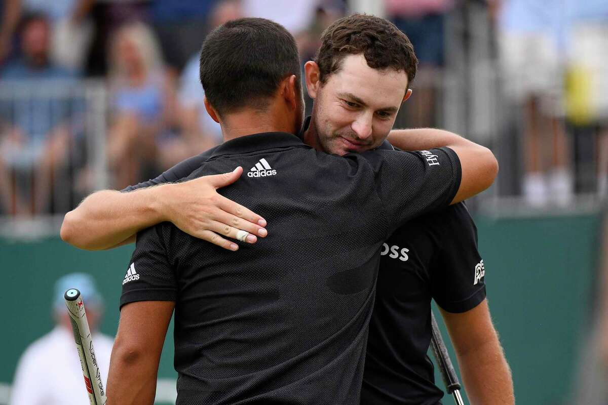 Patrick Cantlay (right) is congratulated by Xander Schauffele after winning the BMW Championship.