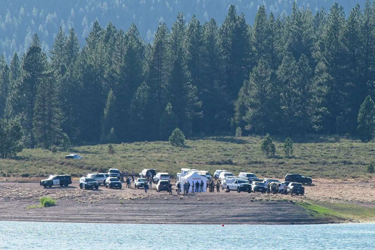 Search and law enforcement personnel gather at the edge of Prosser Reservoir to investigate a report of a vehicle submerged in the lake, possibly belonging to the missing teen.