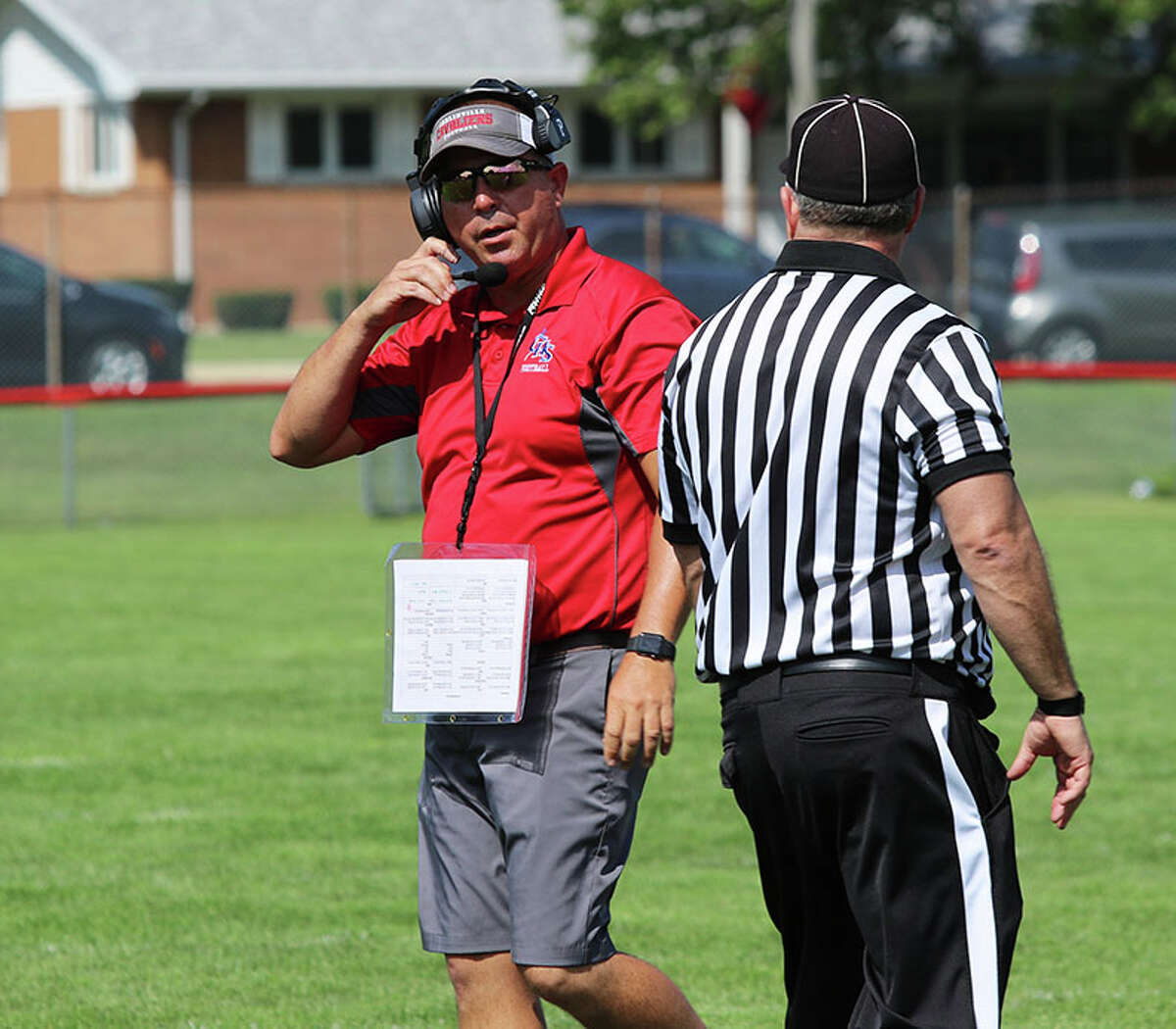 Carlinville coach Chad Easterday (left) has a word with an official during last season's Week 1 win at Gibson City. Easterday begins his 15th season having never missed the playoffs while posting a 112-39 record.
