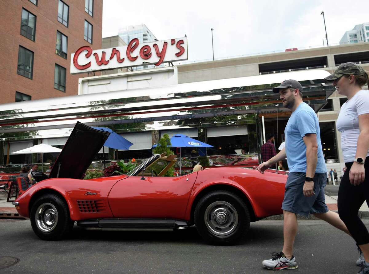 A red Corvette Stingray is parked outside Curley's Diner at the Cruising Stamford auto show at Columbus Park in Stamford, Conn. Sunday, August 21, 2022. More than 150 vintage cars up to the early 80s line Main Street, featuring live music, outdoor dining, face painting, prizes and more. The event, now in its second year, was presented by First Bank of Greenwich, Synergy1Holdings and BlackRoads Auto Club to honor Eversource Energy and the US Postal Service.