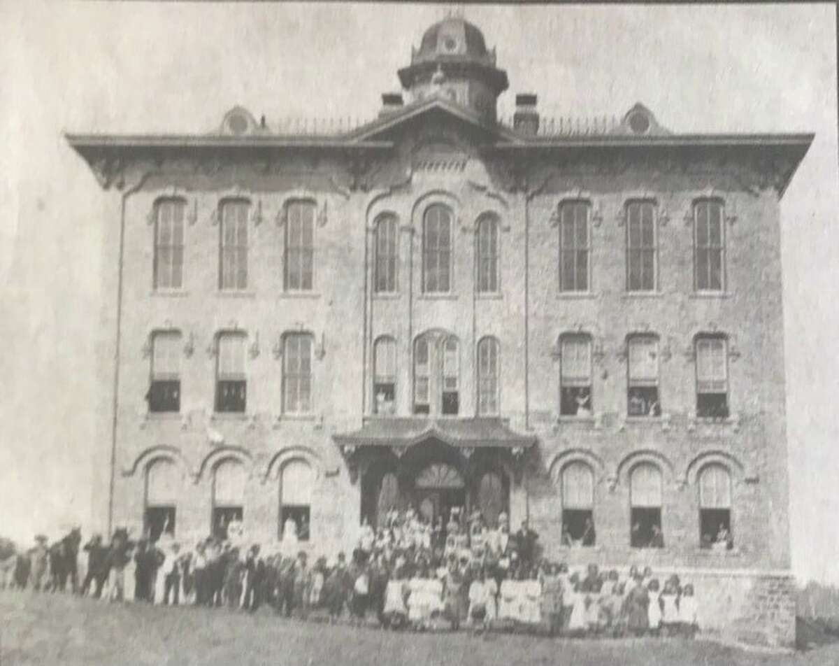 Union School in 1875 with students and teachers. The school on Grove Street at the end of McDonald Street (today Grove Park), housed grades one through 12 with elementary students on the first floors and secondary students on the second floor. A gymnasium was on the third floor.