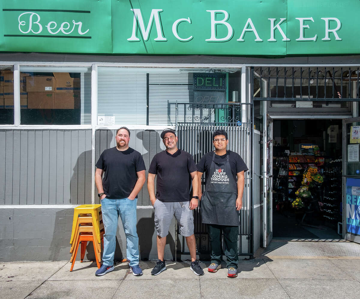 Left to right, Mohannad Alkhouri, Joey Jada and Arturo Suastegui post up in front of McBaker Market & Deli from where Hella Hummus originates on Friday afternoon, Aug. 12, 2022.