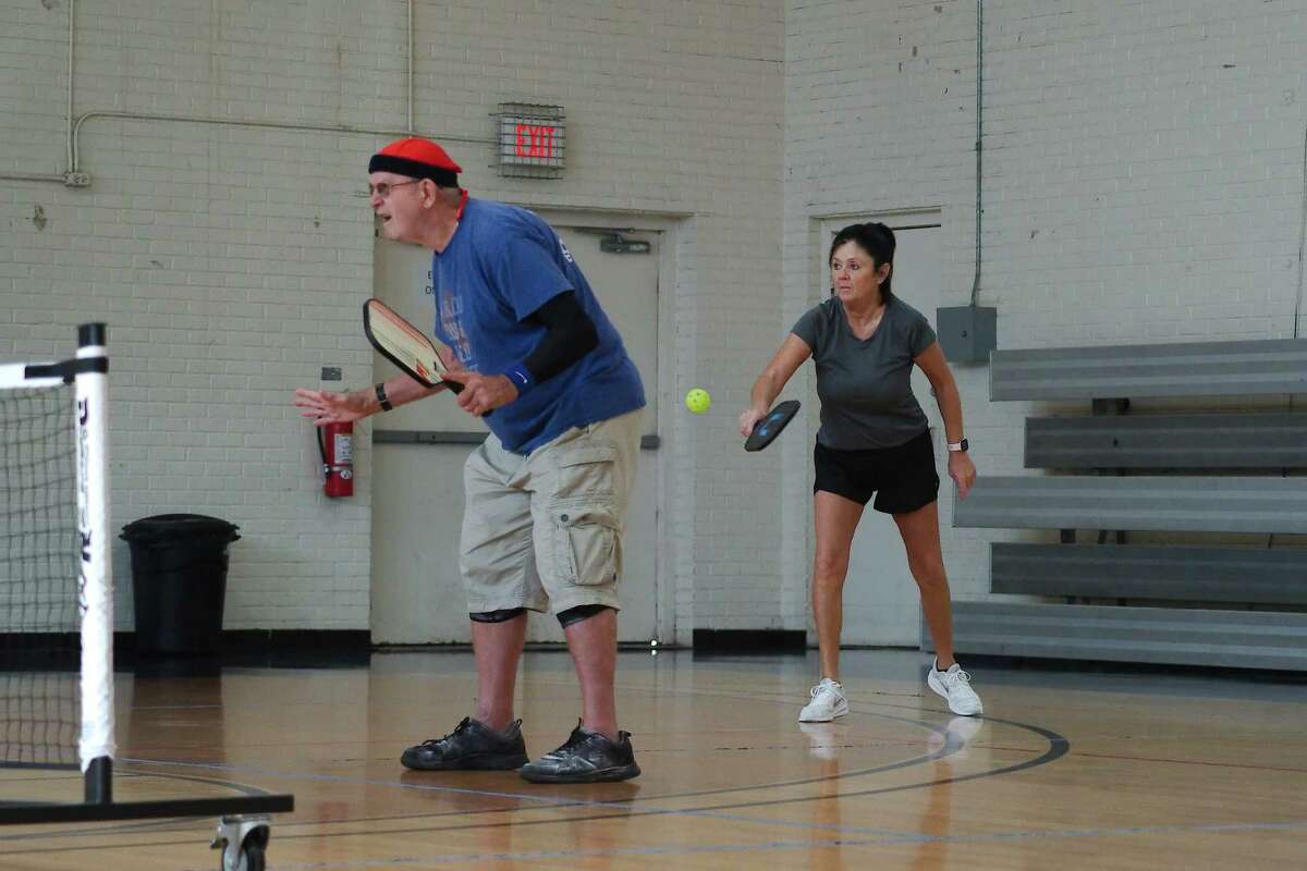 Ken Campbell and Debbie Ozbirn compete in a pickleball doubles match at PAL Gymnasium in Pasadena.
