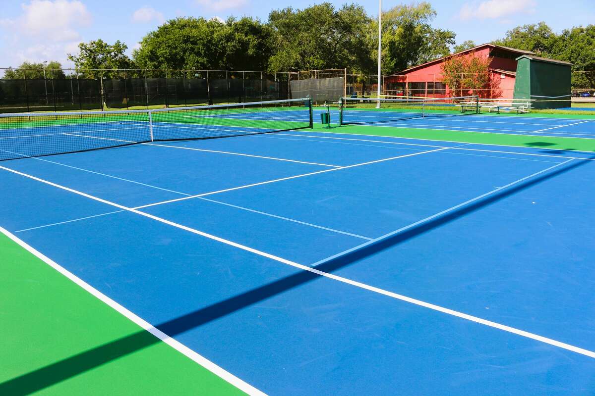 The newly resurfaced tennis courts at Strawberry Park will also be used for pickleball. The blue lines mark the pickleball court boundaries.