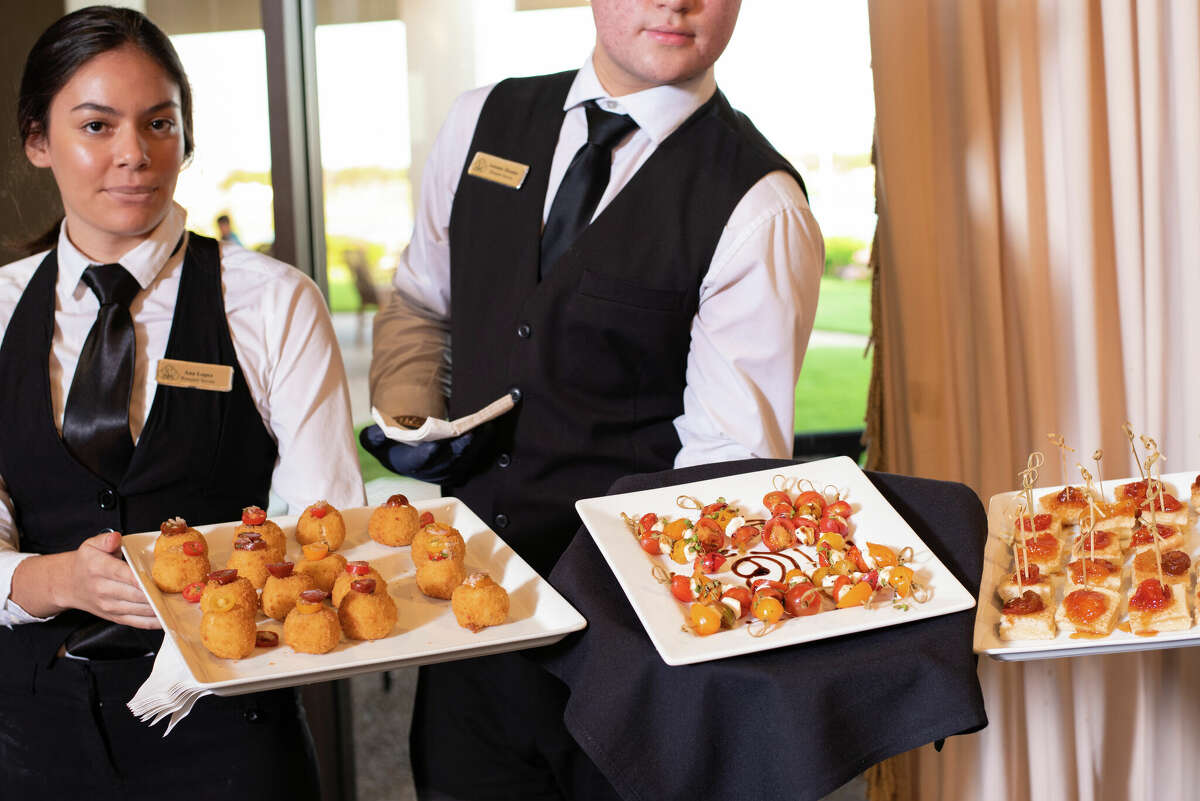 Waiters serving appetizers at Laredo Country Club Friday, Aug. 19, 2022 for the Laredo Fashion Week Kick-Off Cocktail Event for the designers.