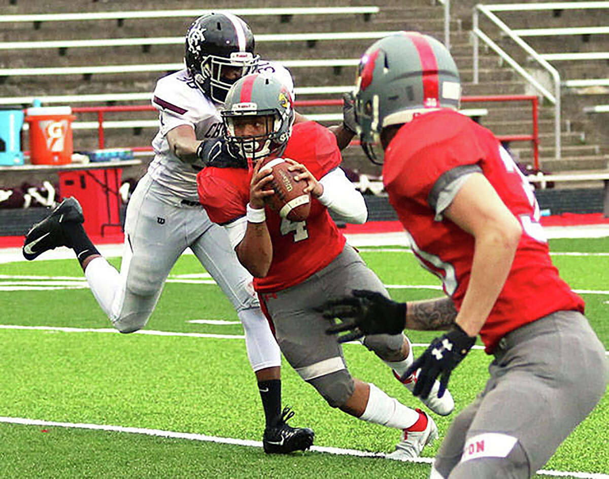 Alton senior running back Keith Gilchrese picks up yardage during a game last season. Alton coach David Parker said Gilchrese is one of the returning AHS players to watch in 2022.
