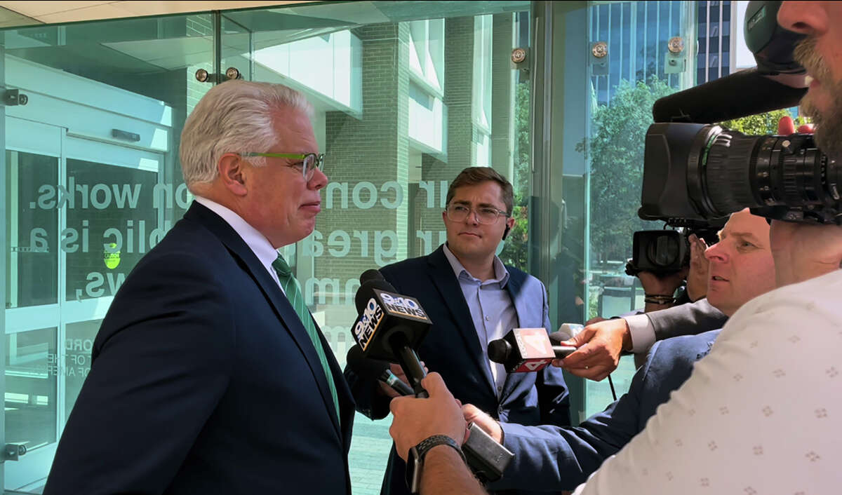 Attorney Christopher Gibbons, left, representing Adam Fox, speaks with the media outside the federal courthouse in Grand Rapids, Mich., following closing arguments in the trial of Fox and Barry Croft Jr., Monday, Aug. 22, 2022.