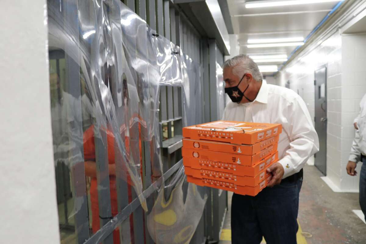 Webb County Sheriff Martin Cuellar delivers pizza to inmates of the Webb County Jail on Friday, Aug. 19, 2022 as part of a new program to reward inmates for winning different challenges.