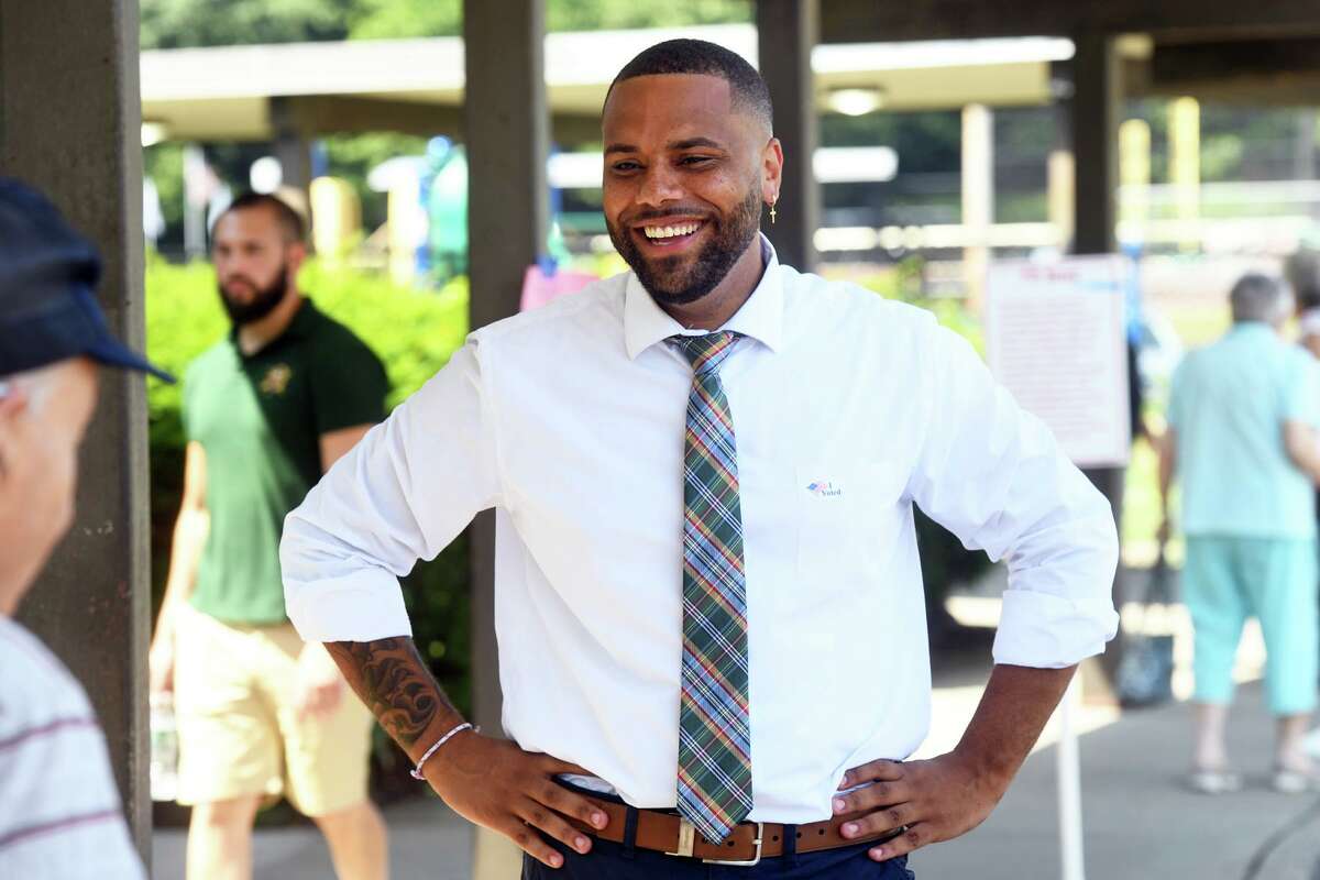 City Councilman Marcus Brown greets voters outside of Blackham School in Bridgeport, Conn. Aug. 9, 2022. Brown challenged incumbent State Rep. Jack Hennessy in Tuesday’s Democratic primary for 127th house seat.