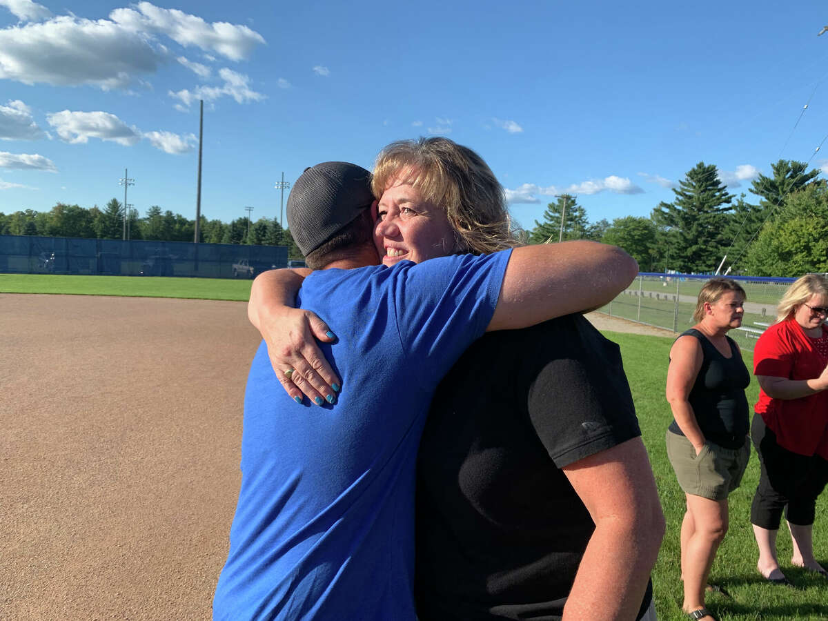 Meridian softball coach Jamie Smith (right) greets supporters during a surprise ceremony honoring her contributions to Meridian athletics on Monday, Aug. 22, 2022.