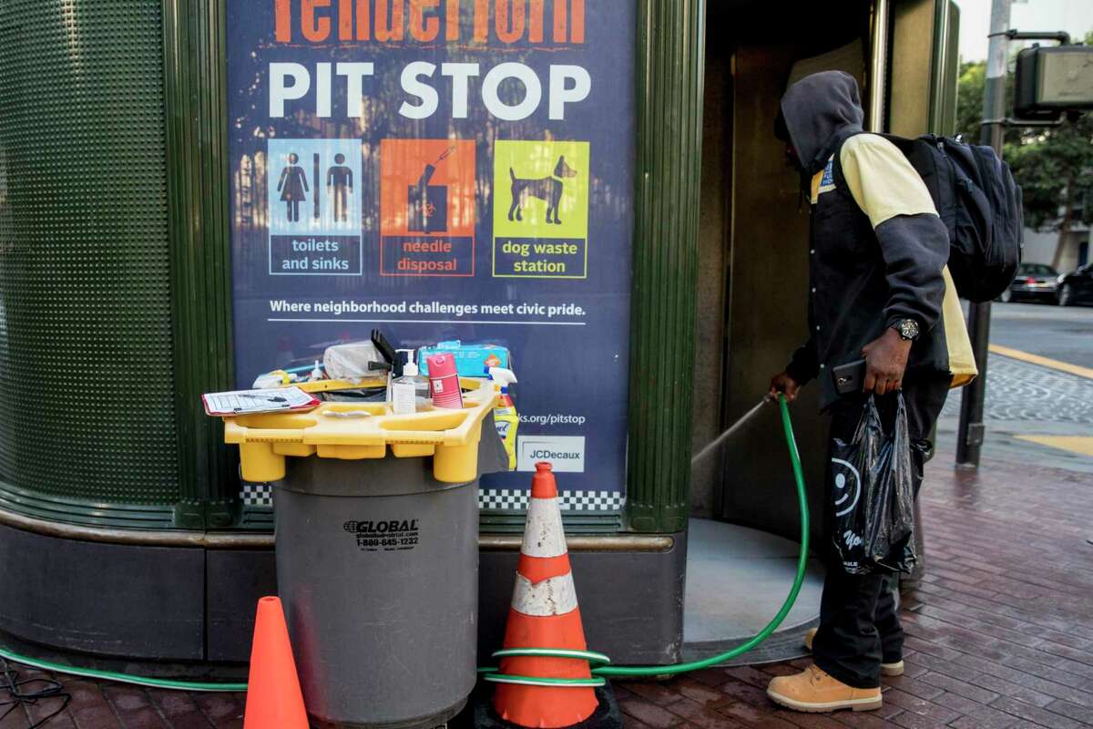 An attendant cleans a Pit Stop Program restroom in the Tenderloin district of San Francisco.