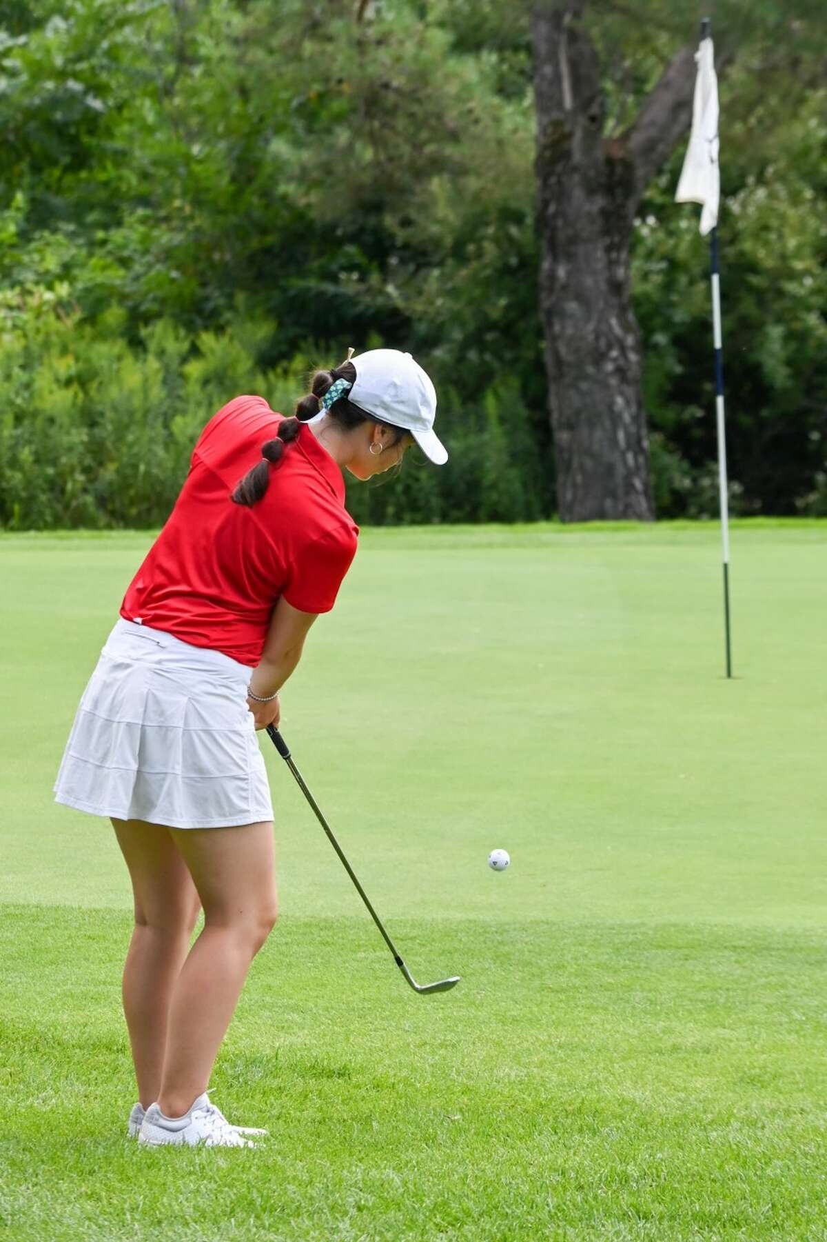 Big Rapids' Kate Posey watches her ball roll up to the cup during CSAA action on Monday at Brookside Golf Course.