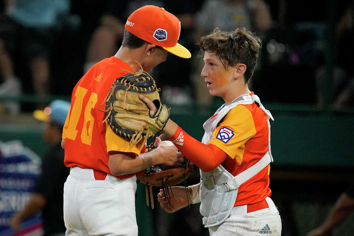 Pearland, Texas, pitcher Jackson Wolfe (16) gets a visit from catcher Ford Hill during the third inning of a baseball game against Honolulu at the Little League World Series in South Williamsport, Pa., Monday, Aug. 22, 2022. (AP Photo/Gene J. Puskar)