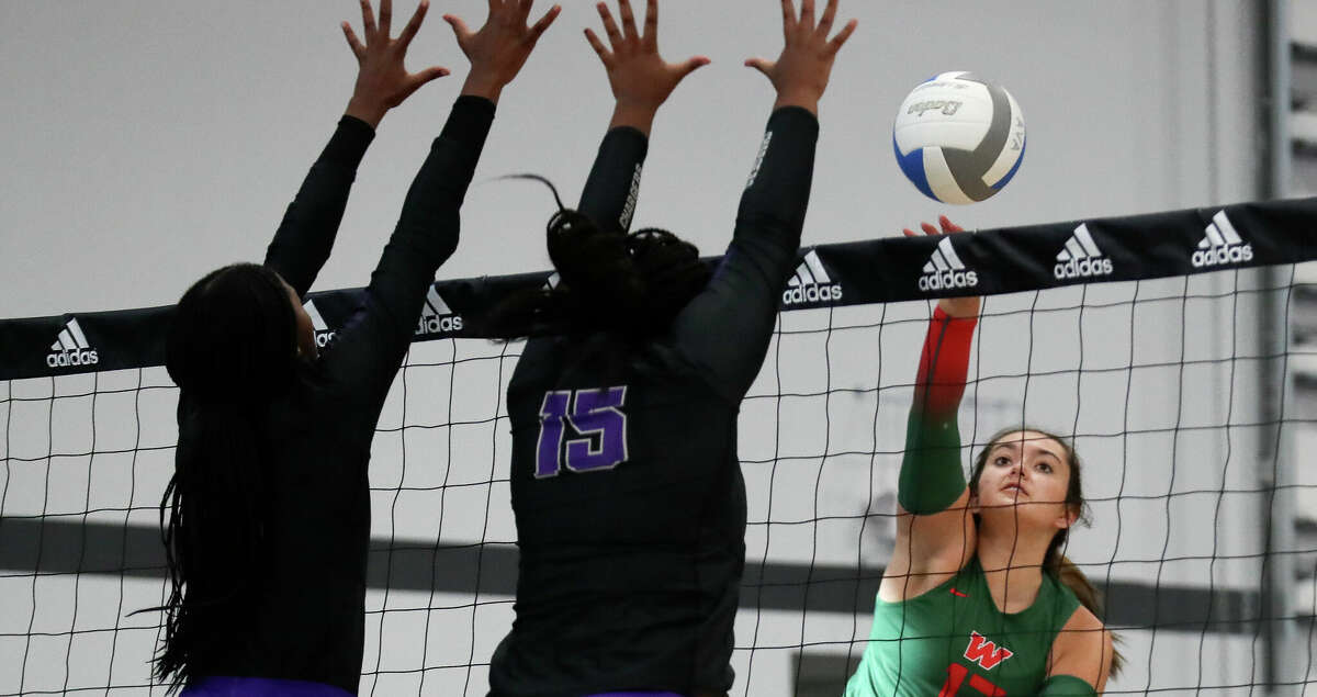 The Woodlands' Claire DeWine (17) gets a shot past Fulshear's Victoria Powell (15) in the first set of a non-district high school volleyball match during the Adidas John Turner Classic, Friday, Aug. 12, 2022, in Webster.