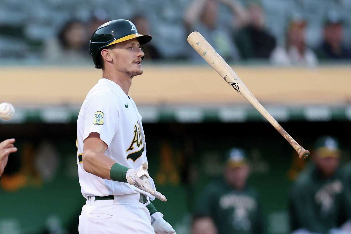 OAKLAND, CALIFORNIA - AUGUST 22: Sean Murphy #12 of the Oakland Athletics tosses his bat in the air after striking out in the first inning against the Miami Marlins at RingCentral Coliseum on August 22, 2022 in Oakland, California. (Photo by Ezra Shaw/Getty Images)