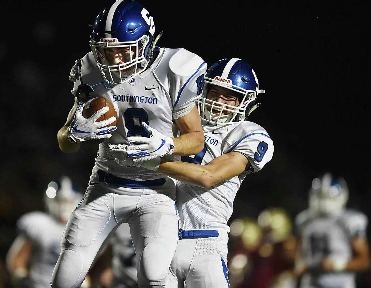 Southington wide receivers Jacob Flynn (8) and Will Downes (9) celebrate after Flynn's fourth quarter touchdown against New Britain in 2018.