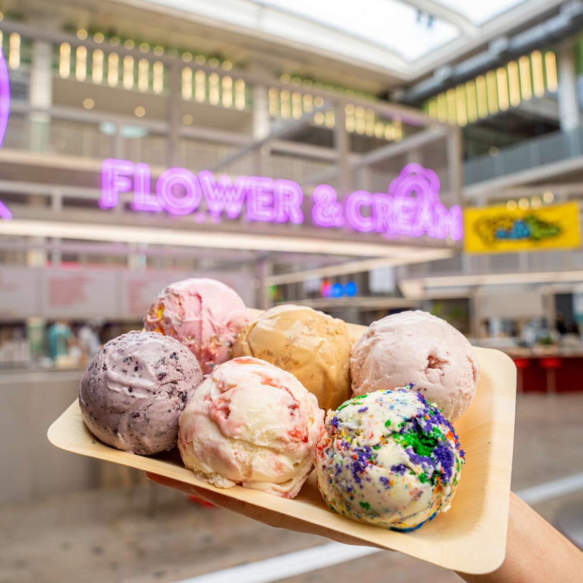 Six scoops of ice cream from Houston's Flower & Cream are shown on a tray.