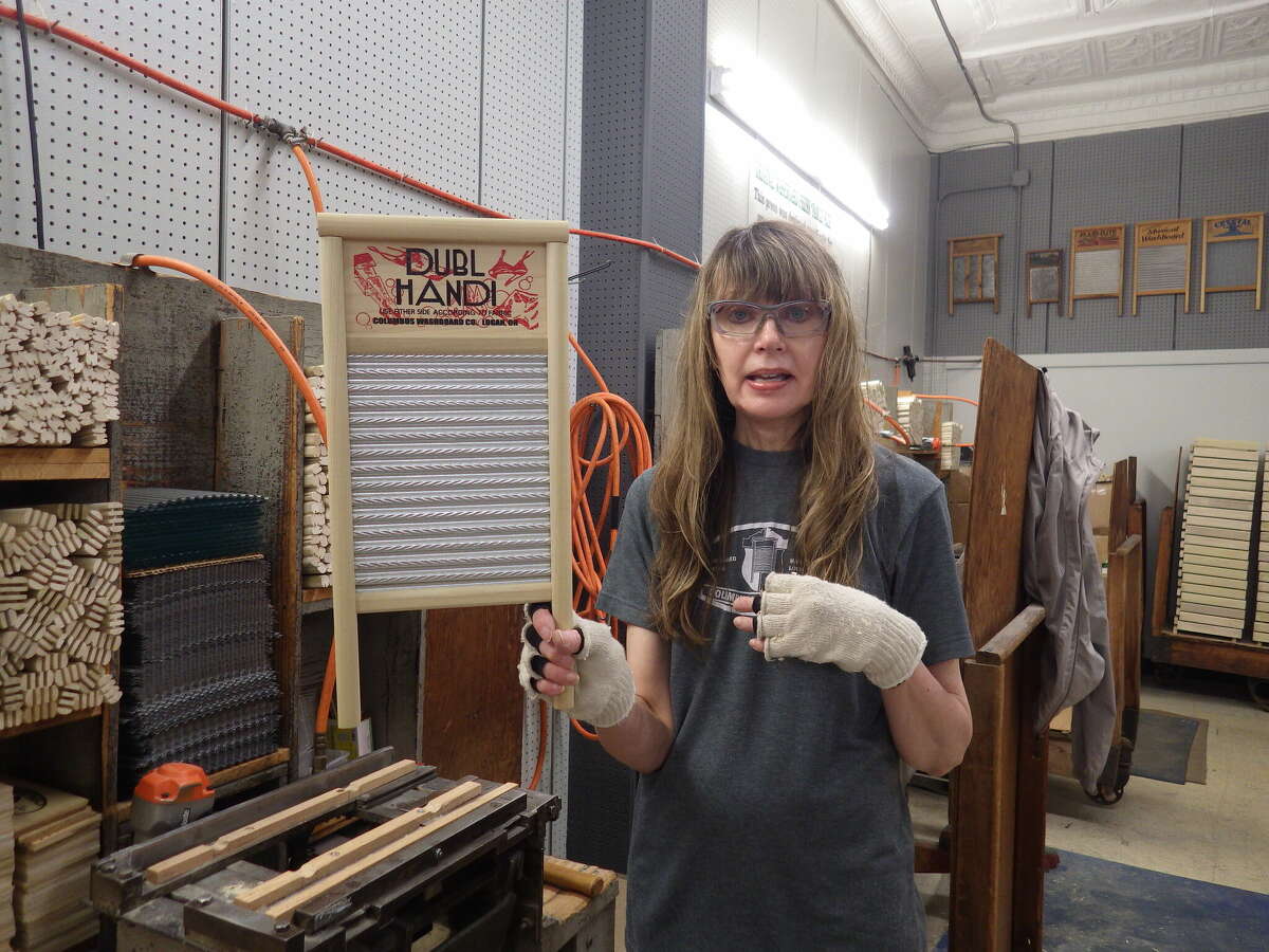 Lisa Jarrell holds a washboard that she assembled very quickly. She is cross-trained to do everything at the Columbus Washboard Factory in Logan, Ohio, which manufactures 20,000 washboards annually.