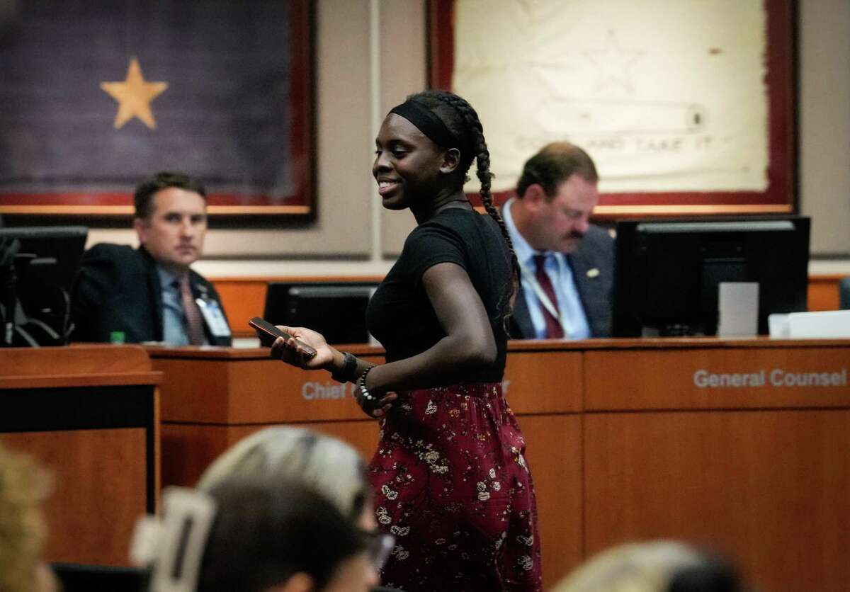Jennifer Edozie, 17, a senior at Cinco Ranch High School, smiles as she walks back to her seat after speaking during a school board meeting Monday, Aug. 22, 2022, at Katy ISD Educational Support Complex in Katy. Edozie spoke against removing titles from school libraries, as some people are advocating.