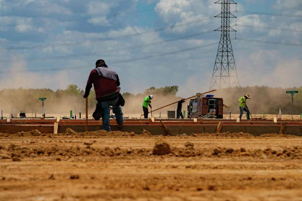 Crews at work on developments on what was once prairie land, Thursday, July 7, 2022, in Katy.