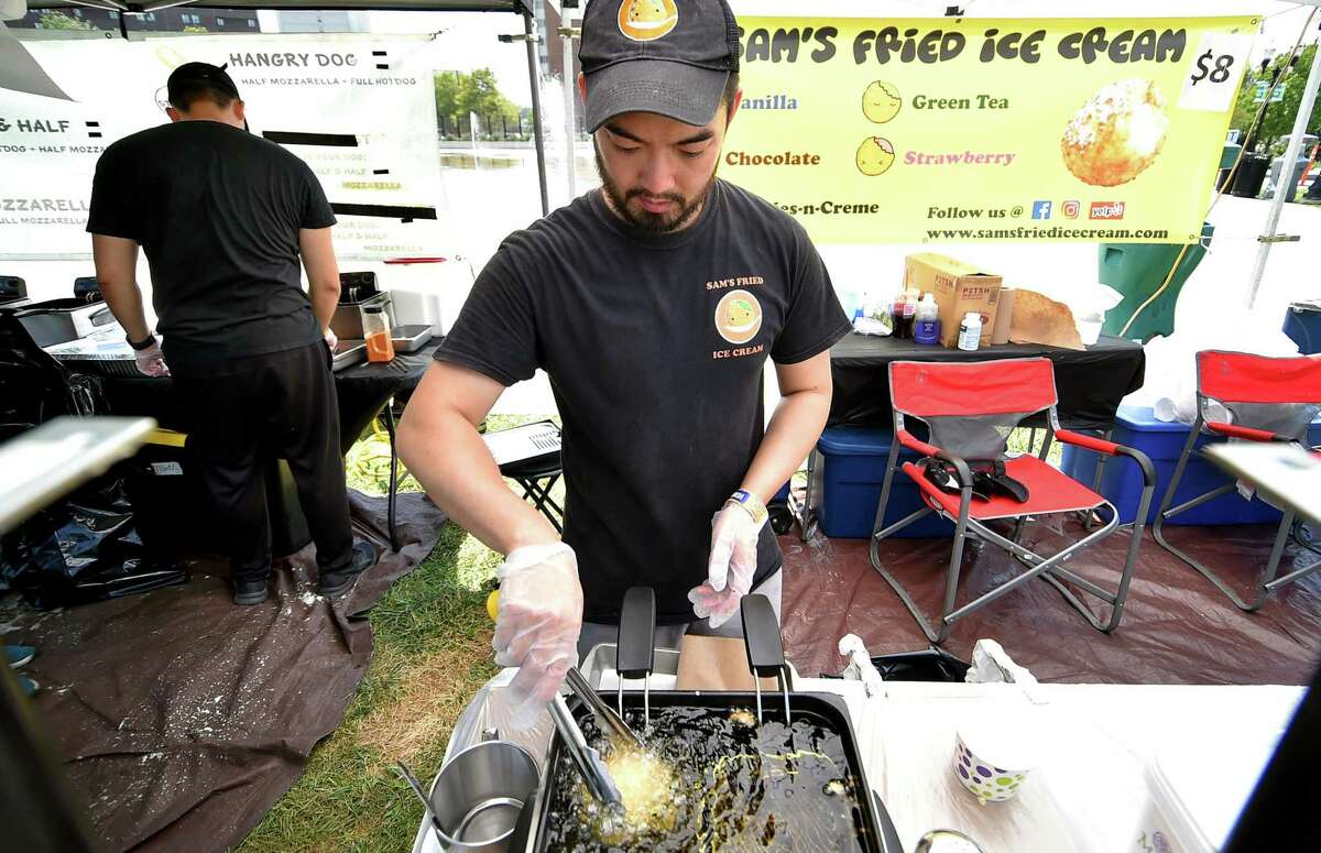 Jason Chen, with Sam's Fried Ice Cream, cooks a customer's order during the Hey Stamford! Food Festival at Mill River Park in Stamford, Conn., on Saturday August 20, 2022. Sunday is the final day of the festival at will feature Vanilla Ice, Rob Base and All For One as part of the I Love the 90's tour.