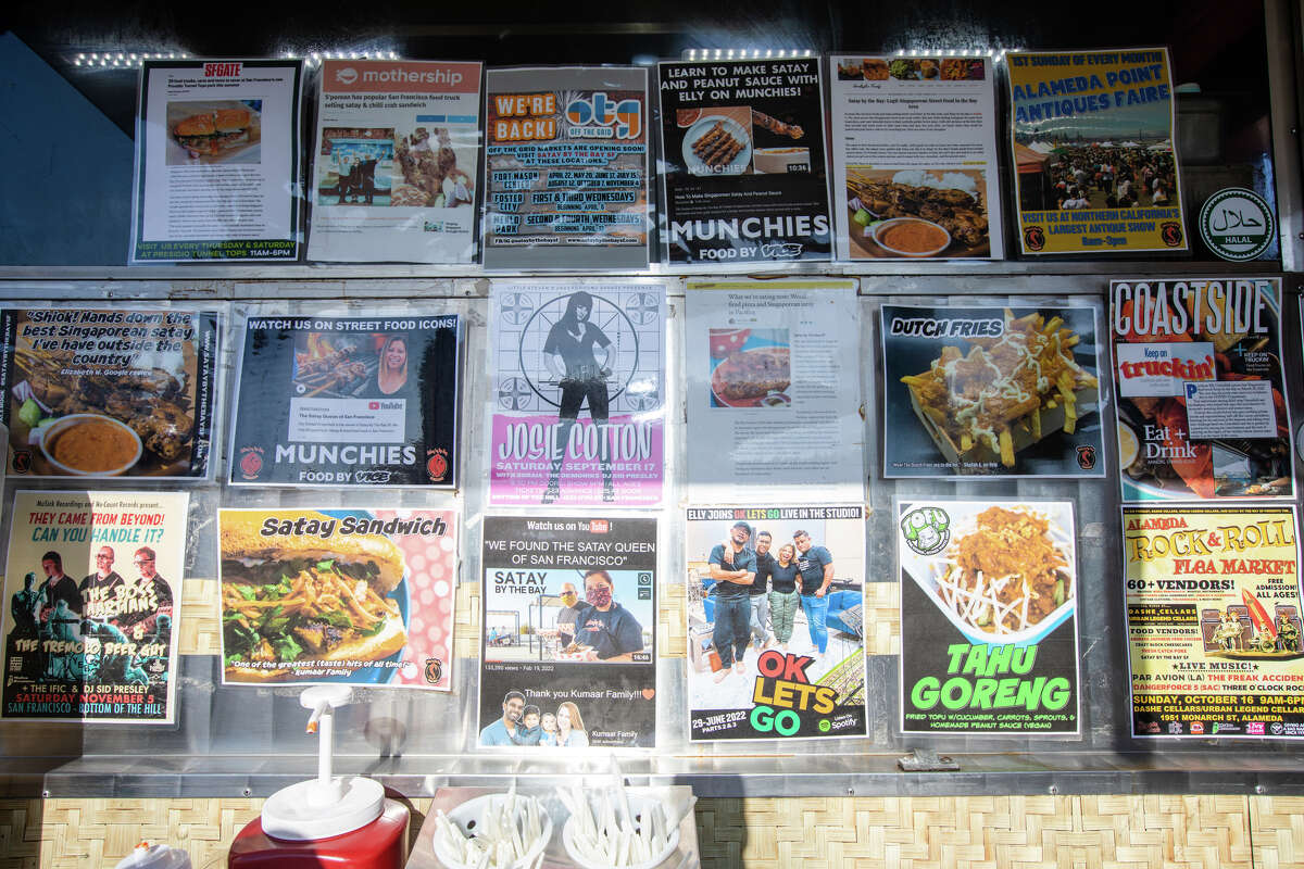 Articles about Satay by the Bay and concerts promoted by David Greenfield are attached to the side of their food truck at Off The Grid at Fort Mason in San Francisco, Calif. on Aug. 19, 2022.