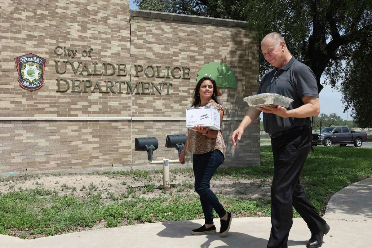 Lorena Garcia and Carlos Sanchez deliver food at the Uvalde, Texas police department, Monday, Aug. 22, 2022. A delegation from Montgomery County and Conroe, Texas delivered food for first responders in Uvalde. The group, together with Love Heals Youth, raised $35,000 in June after Conroe restaurateur, Joe Haliti and Texas Ranger Wesley Doolittle wanted to do something for the city of Uvalde. Food was provided to first responders and equipment and supplies were donated for the Utopia ISD therapy room in nearby Utopia, Texas. Love Heals Youth is a non-profit that provides therapeutic services to foster youths in group homes.
