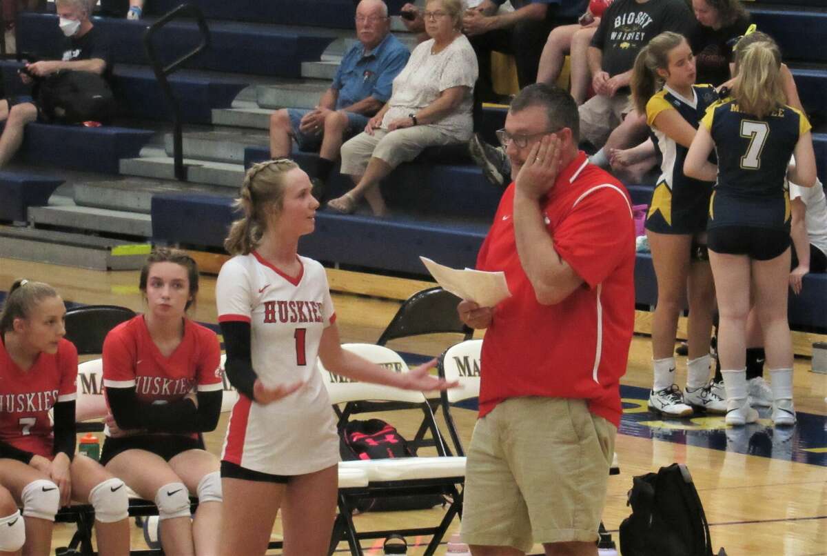 Benzie Central junior Sky Hawkins and coach Corey Bechler have a discussion during a match against Manistee on Aug. 23 at manistee High School.