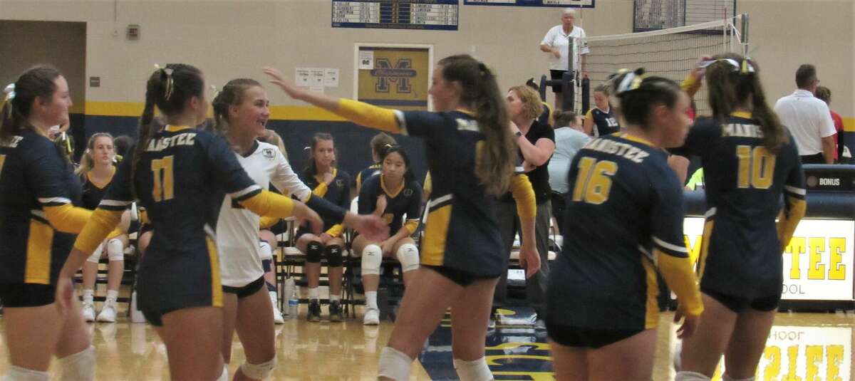 The Manistee volleyball team celebrates a point during a match against Benzie Central on Aug. 23. 