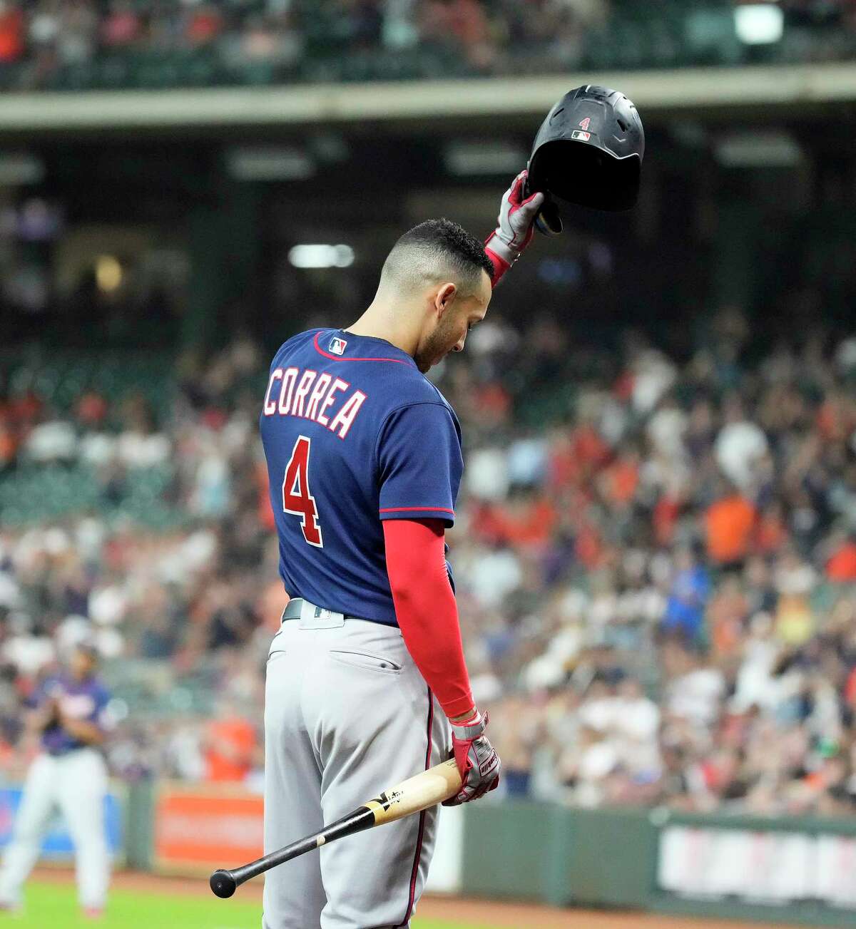 Minnesota Twins Carlos Correa (4) waves to the crowd as he prepared for his at bat against Houston Astros starting pitcher Justin Verlander during the first inning of an MLB baseball game at Minute Maid Park on Tuesday, Aug. 23, 2022 in Houston.