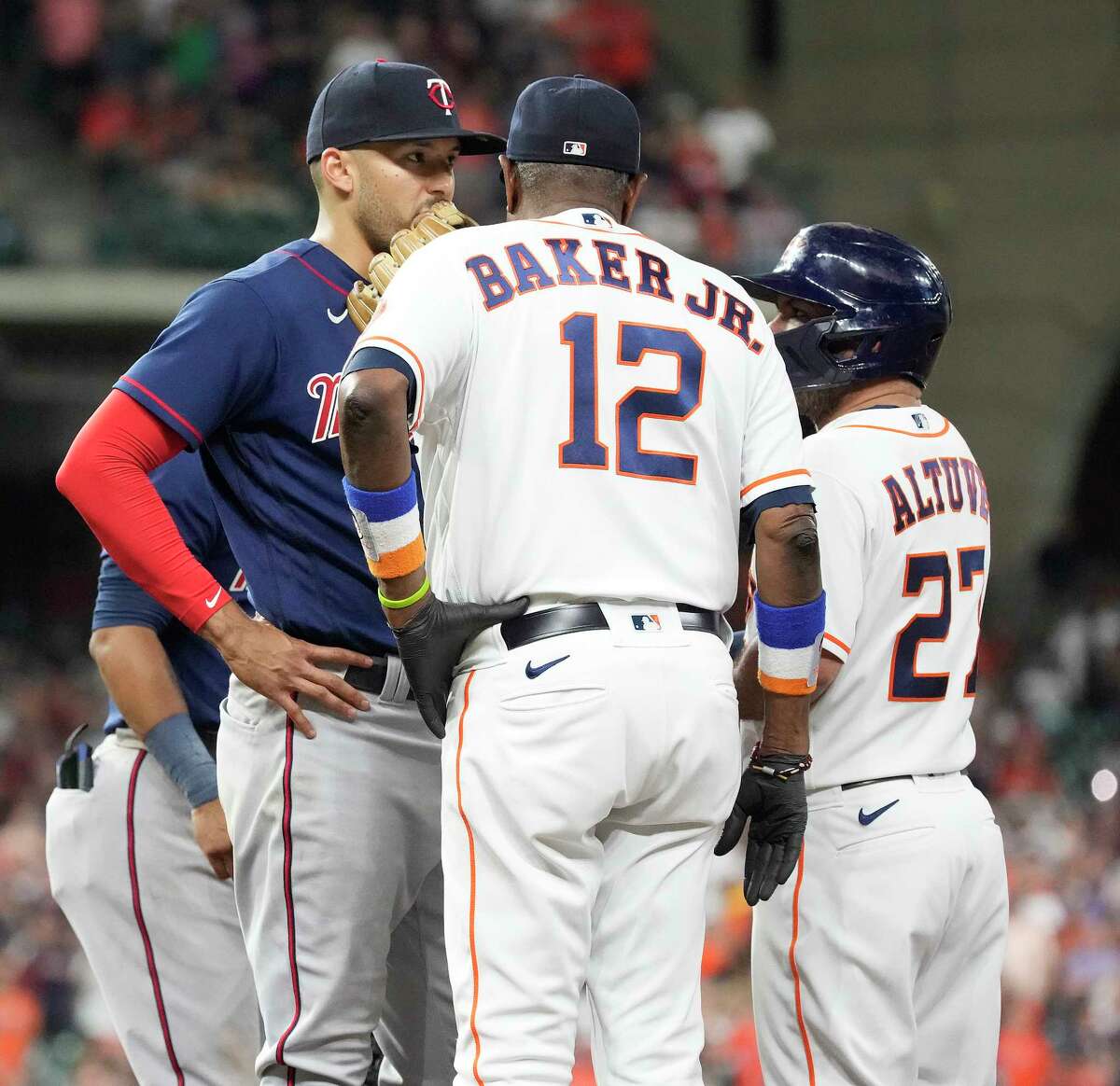 Minnesota Twins shortstop Carlos Correa (4) approaches Houston Astros Jose Altuve (27) after he was hit by a pitch from Minnesota Twins starting pitcher Aaron Sanchez during the fifth inning of an MLB baseball game at Minute Maid Park on Tuesday, Aug. 23, 2022 in Houston.