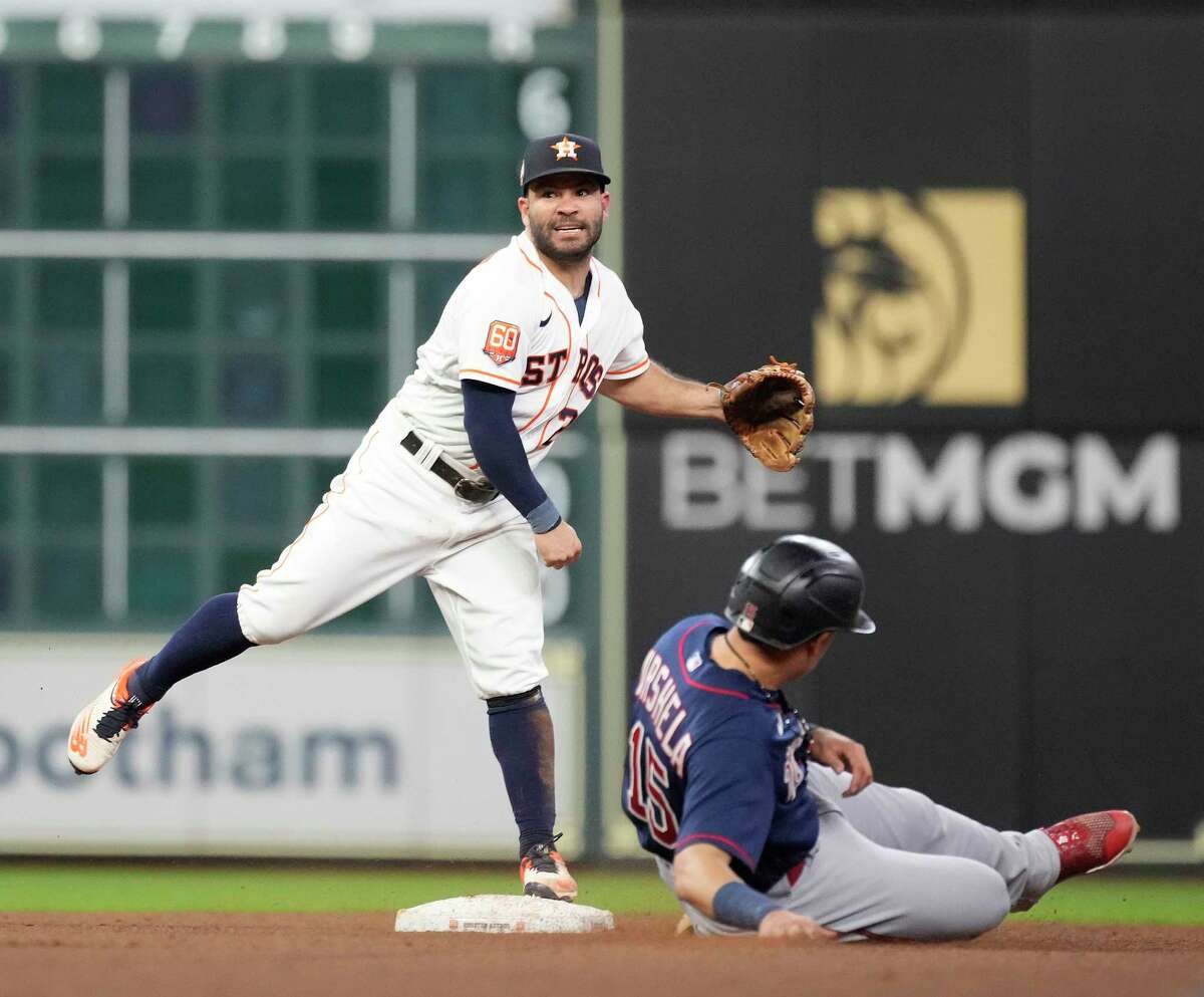 Houston Astros second baseman Jose Altuve (27) makes the throw to first as Minnesota Twins Gary Sanchez (24) ground into a double play to end the top of the eighth inning of an MLB baseball game at Minute Maid Park on Tuesday, Aug. 23, 2022 in Houston.