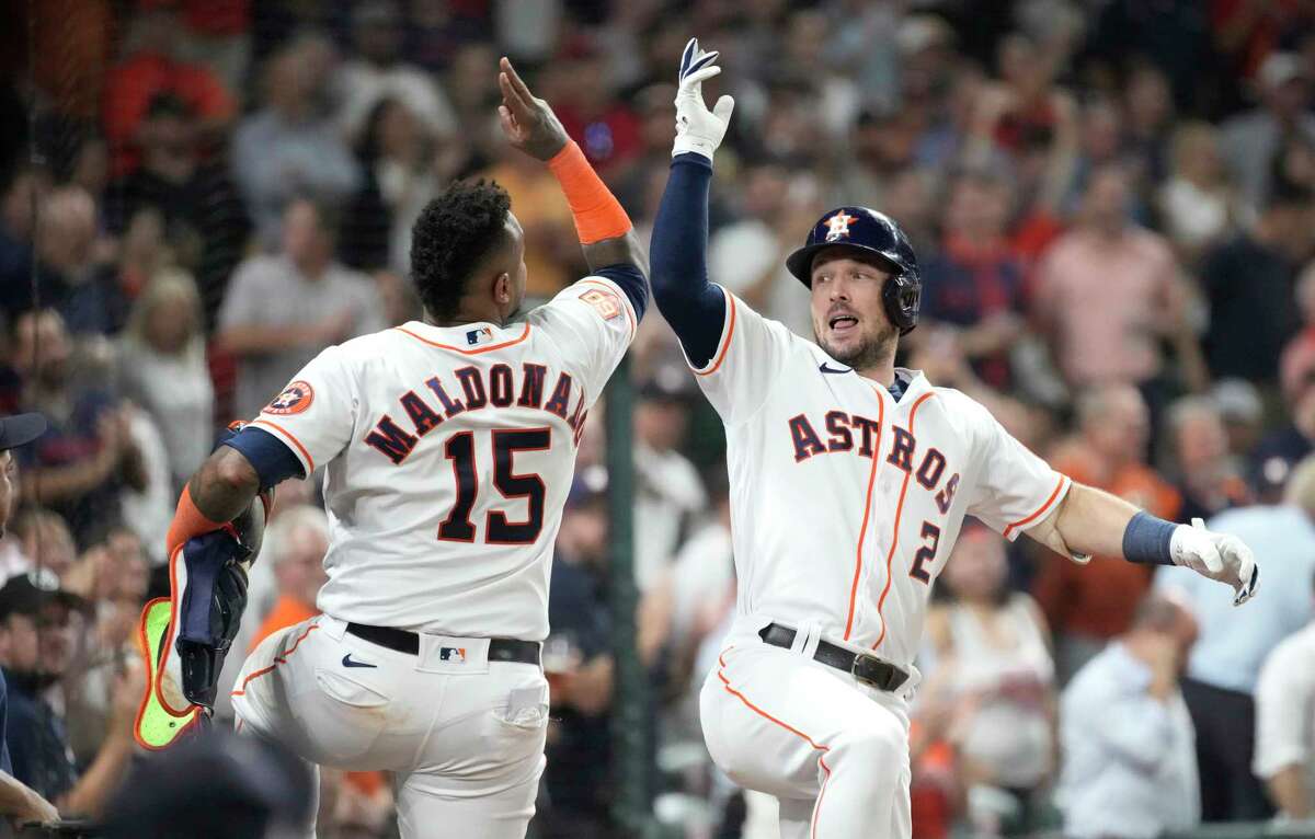 Houston Astros Alex Bregman (2) celebrates with Martin Maldonado (15) after hitting a two-run home run against Minnesota Twins relief pitcher Trevor Megill during the seventh inning of an MLB baseball game at Minute Maid Park on Tuesday, Aug. 23, 2022 in Houston.