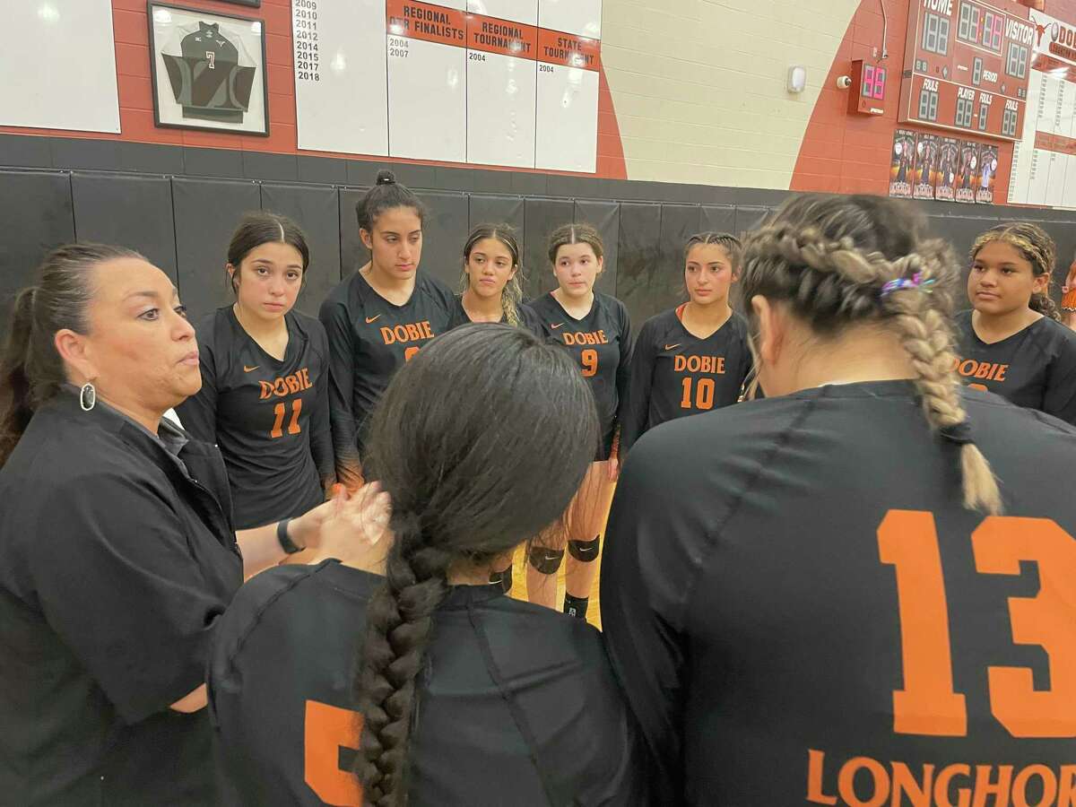 Dobie huddles prior to the start of Game 3 Tuesday night as the Lady Longhorns prepared to celebrate a 3-0 win.