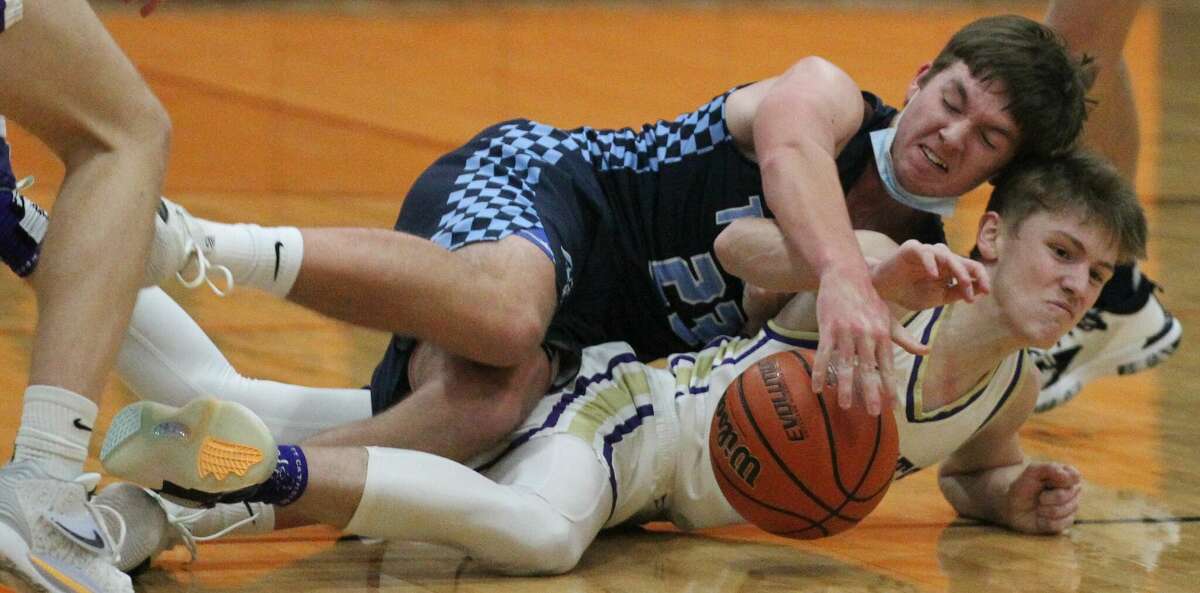 Players go after a loose ball during a boys' basketball game between Triopia and Routt last season.